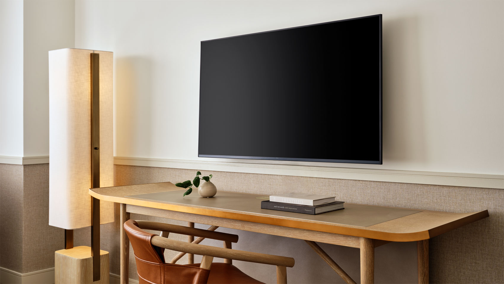 guestroom with desk, lamp and tv at 70 Park Ave