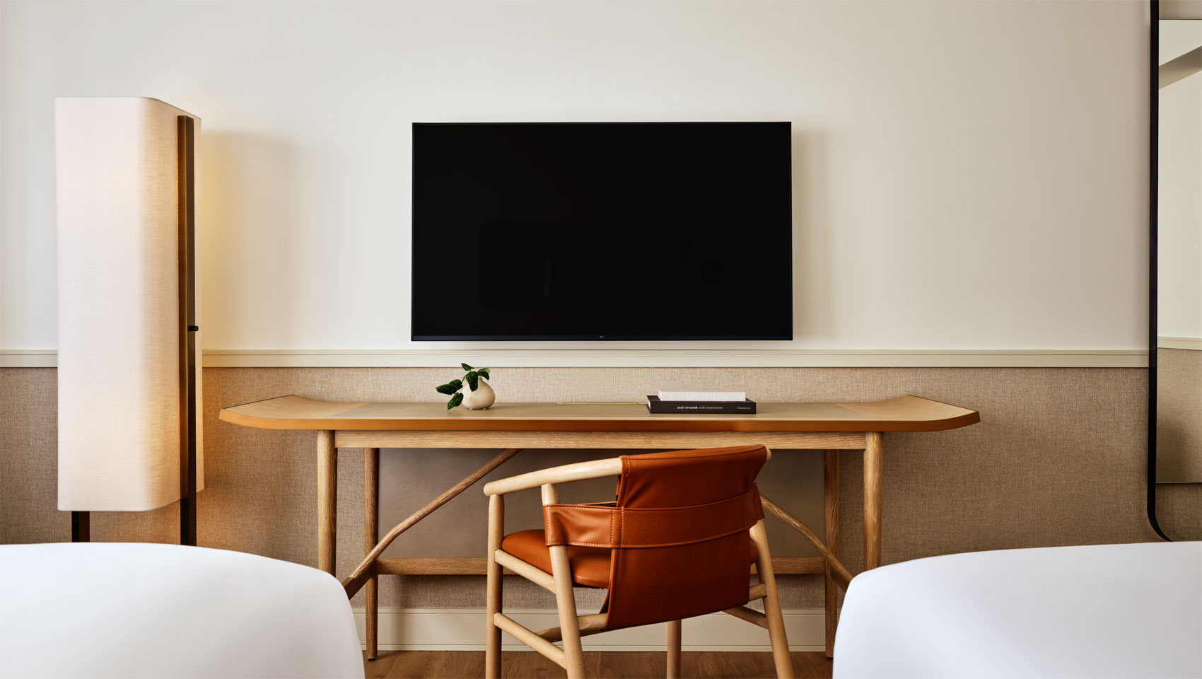 guestroom two beds, desk, lamp and TV at 70 Park Ave